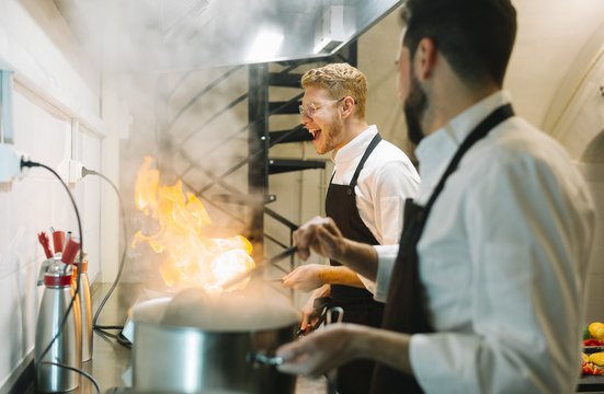 Chefs cooking flambe in the kitchen
