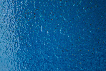 Background image of blue textured metallic surface close-up. Iron surface painted in blue.