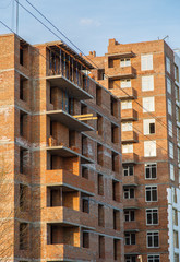 construction of brick house multi-storey residential building. Details of new constructed multi-story building. Modern residential construction. Residential fund