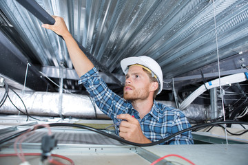 electrician repairing ceiling light
