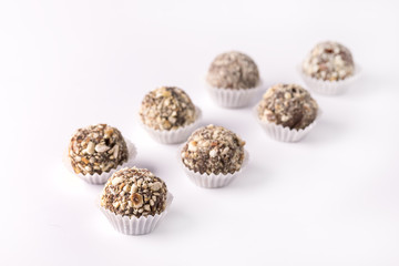 Chocolate Truffles Decorated with Nuts on White Background Beautiful Tasty Homemade Candy Group of Candy