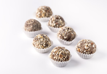 Chocolate Truffles Decorated with Nuts on White Background Beautiful Tasty Homemade Candy Group of Candy