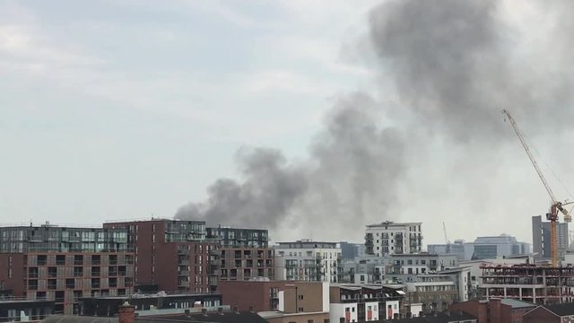 UK April 2018 - Smoke from an industrial blaze billows up and over the city skyline in East London.
