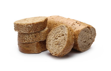 Loaf of whole wheat bread with sesame and slices isolated on white background