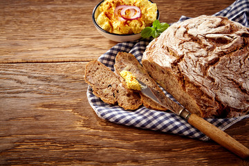 Fresh crunchy Bavarian bread against wooden table