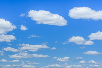 Fototapeta na wymiar White fluffy clouds in a deep blue sky