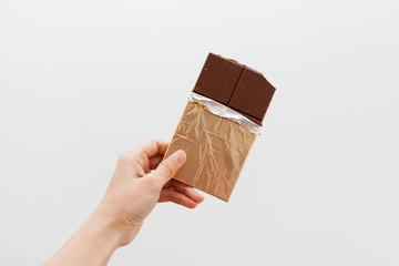 Hand holding a chocolate bar