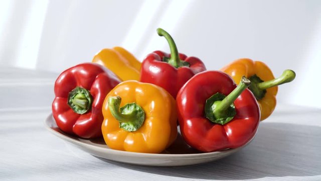 Colored red yellow Bell Pepper Placed on plate. white shaddow background. Healthy eating and lifestyle