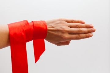 Hand and red ribbon