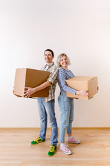 Fototapeta na wymiar Image of young man and woman with cardboard box