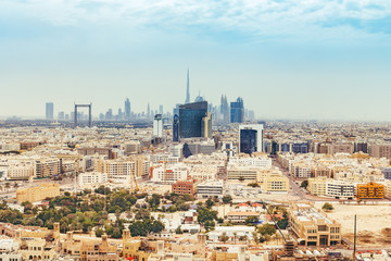 Aerial daytime skyline of Dubai, UAE, with skyscrapers in the distance. Scenic travel background.