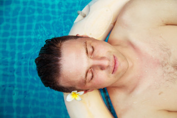 Man relaxes in the pool.