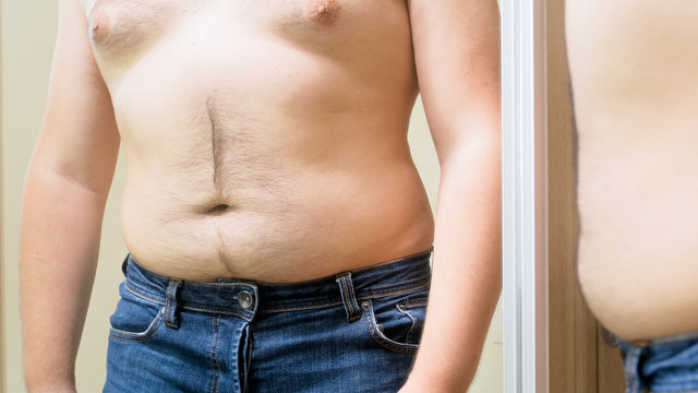 Closeup photo of obese man with big hairy belly