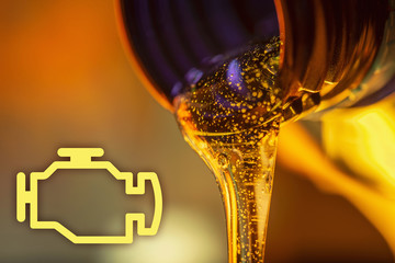 Check engine lamp and liquid stream of motorcycle motor oil flows from the neck of the bottle close-up.