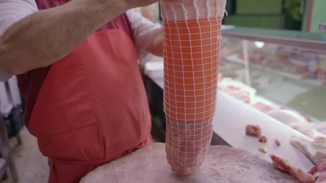 Butcher preparing meat with mesh