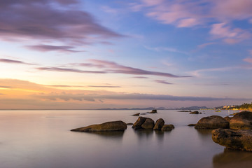 Fototapeta na wymiar Colorful scenic sunset seascape with clouds on the sky and stones in water on Phu Quoc Island in Vietnam