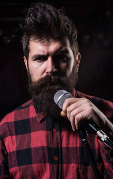 Vocalist concept. Musician with beard and mustache lighted
