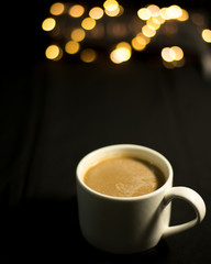 a cup of coffee on the blurred background of led lights 