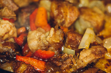 Roast meat, onions, carrots and spices, boiling in oil