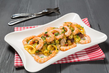 Paella with chicken, shrimp and squid rings