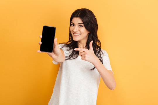 Pretty woman showing display of mobile phone.