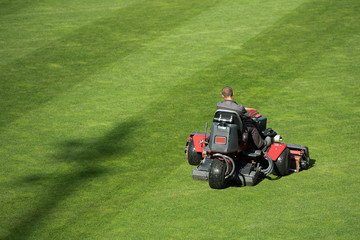 Mowing grass at the football stadium