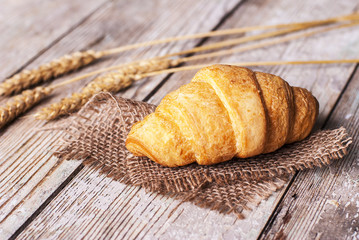 croissant on the table, next to butter and corn