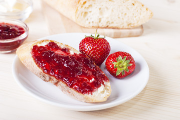 sandwich with strawberry jam on the table