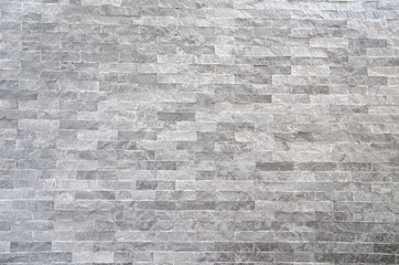 A gray stone wall surface with cement a background texture.