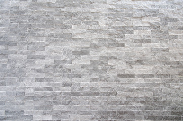 Obraz premium A gray stone wall surface with cement a background texture.