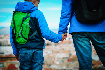 father and son travel in city