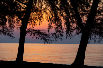 Beautiful big sunrise in the morning sky creates its stunning reflection on the sea wave surface.