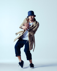 Young beautiful male dancer posing in studio