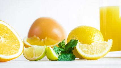 Obraz na płótnie Canvas Closeup image of lemon and orange slices on white wooden desk