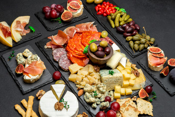 various type of italian meal or snack - cheese, sausage, olives and parma