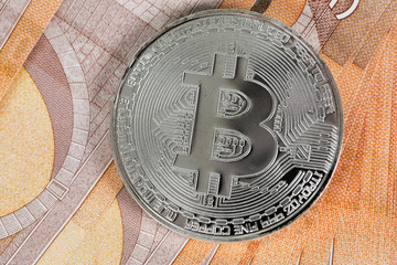 Fototapeta na wymiar Bitcoin on banknotes of 50 euros.