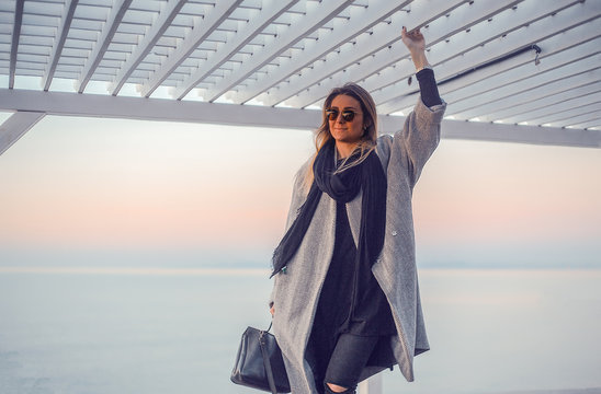 Portrait of woman wearing winter coat and sunglasses looking away, Odessa, Odeska Oblast, Ukraine