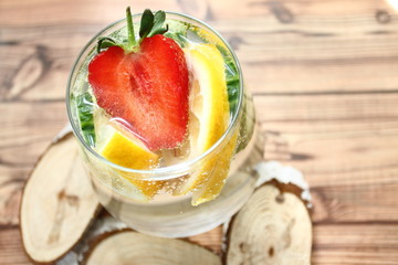 Detox flavored water with lemon, cucumber and  strawberry on white background with decoration. Healthy food concept.  Refreshing summer homemade cocktail. Copy space. No sharpen. 