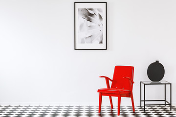 Red armchair in white interior