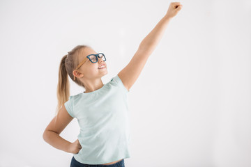 Young girl in superhero pose