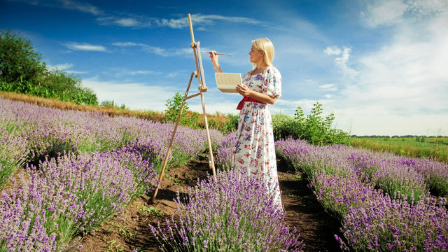 Beautiful smiling woman drawing picture of lavender field at morning