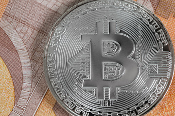 Bitcoin on banknotes of 50 euros.