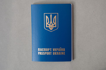 Foreign passport of Ukraine, is isolated on a gray background. Ukrainian traveler. Ukrainian emigrant. Visa-free regime for Ukraine