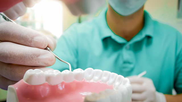 View From Inside Of Patients Mouth Of Dentist Treting Teeth