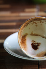 Fallen coffee cup with milk foam.