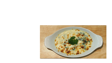 Top View of The Creamed Spinach Casserole or Baked Spinach with Cheese in A White Dish.  Isolated on White Background with Selection Path or Clipping Path Included.