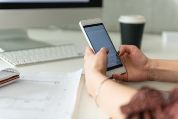 Female hands holding mobile phone