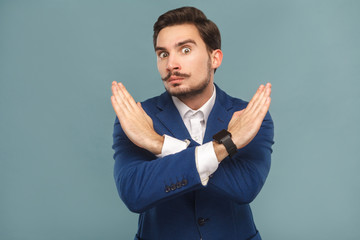 Stop, no! Businessman showing hand ban at camera