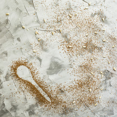 A spoonful of cocoa on a gray background. Dessert food concept. Copyspace