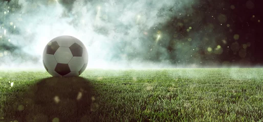 Acrylic prints Soccer Fußball liegt auf Stadionrasen im Rauch